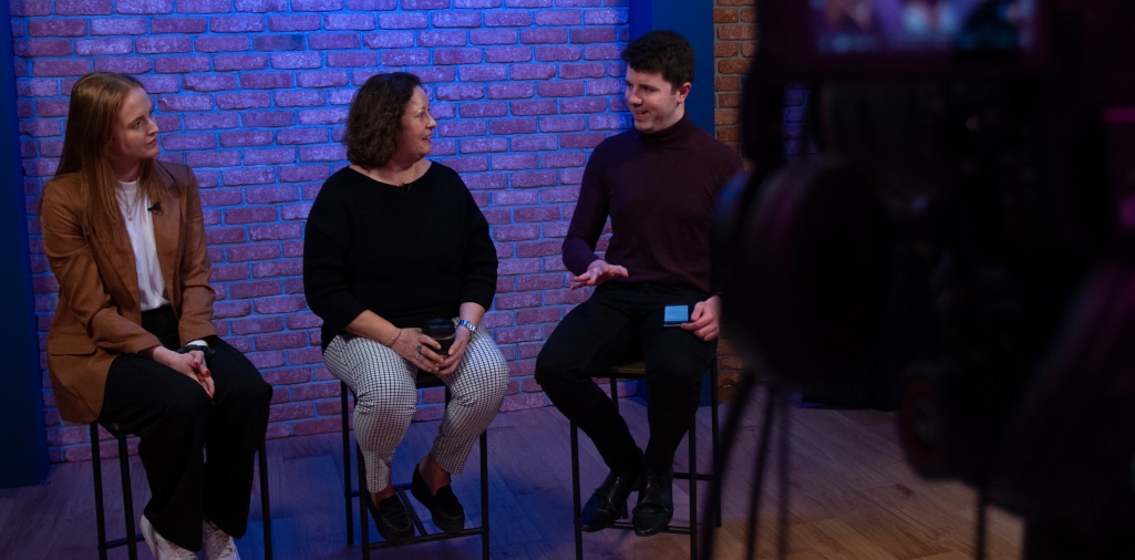 People chatting on camera in a broadcast studio